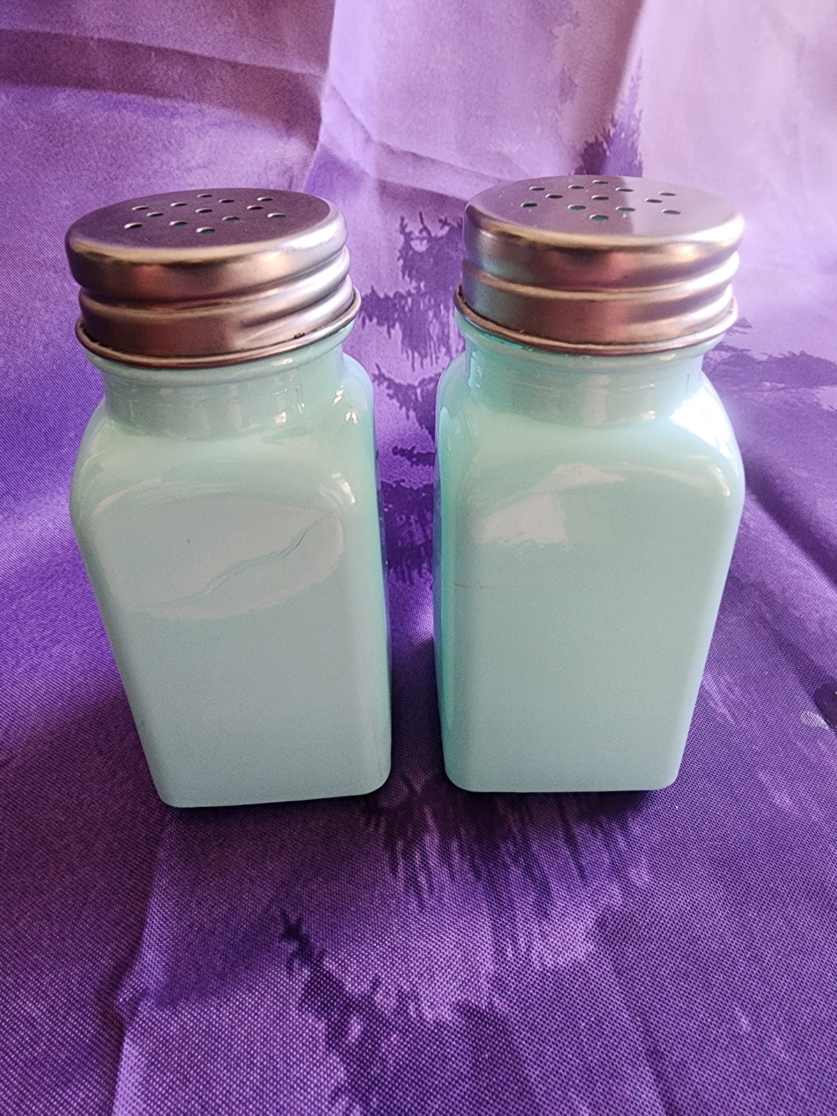 Salt & Pepper Shakers Turquoise Glass and stainless steel tops.