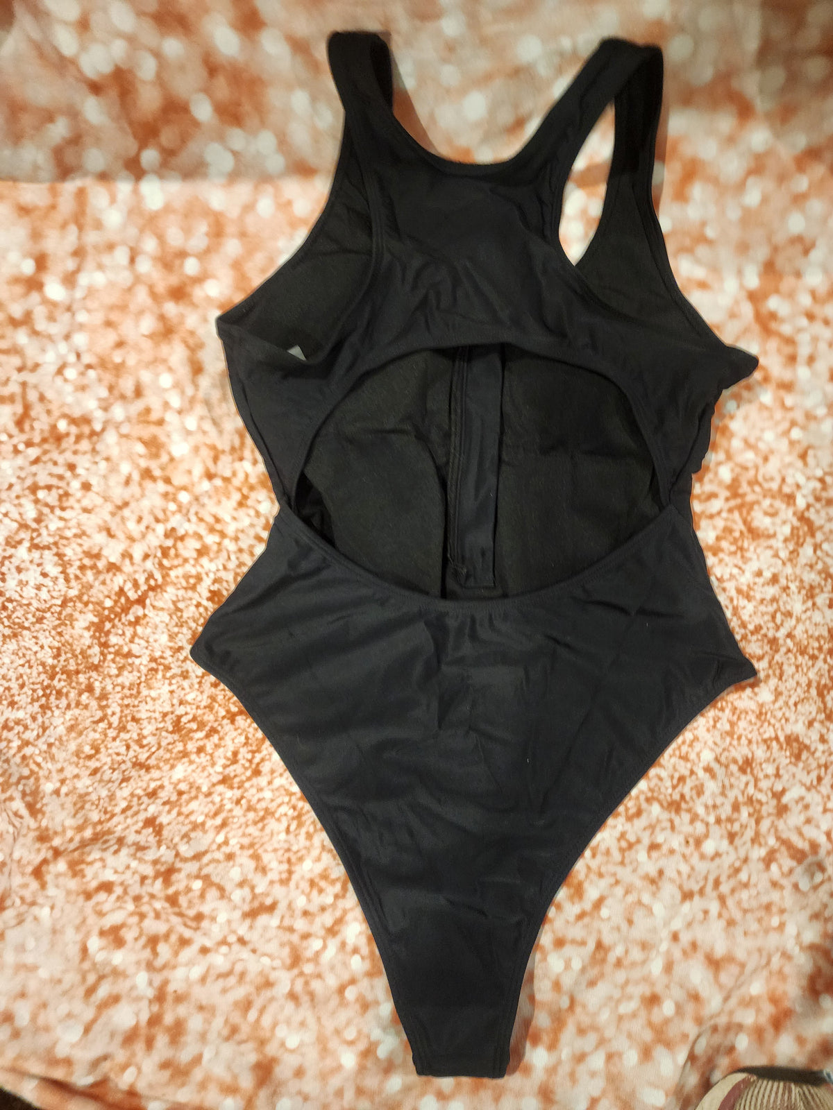 Sleek and stylish black one-piece swimsuit, perfect for the beach or pool L