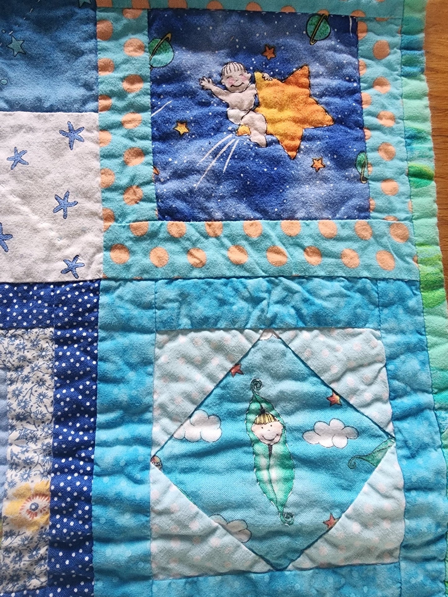 Homemade baby quilt in blues greens and Yellows baby's riding stars. - I Bought a Yard Sale