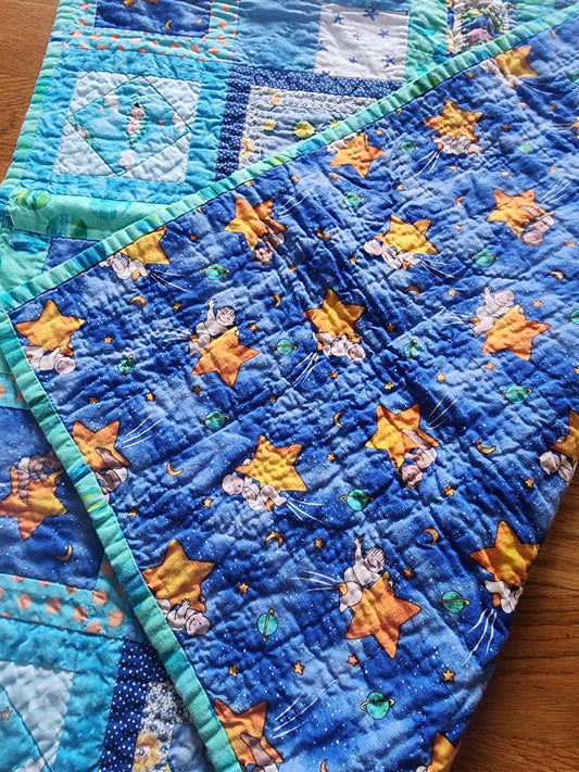 Homemade baby quilt in blues greens and Yellows baby's riding stars. - I Bought a Yard Sale
