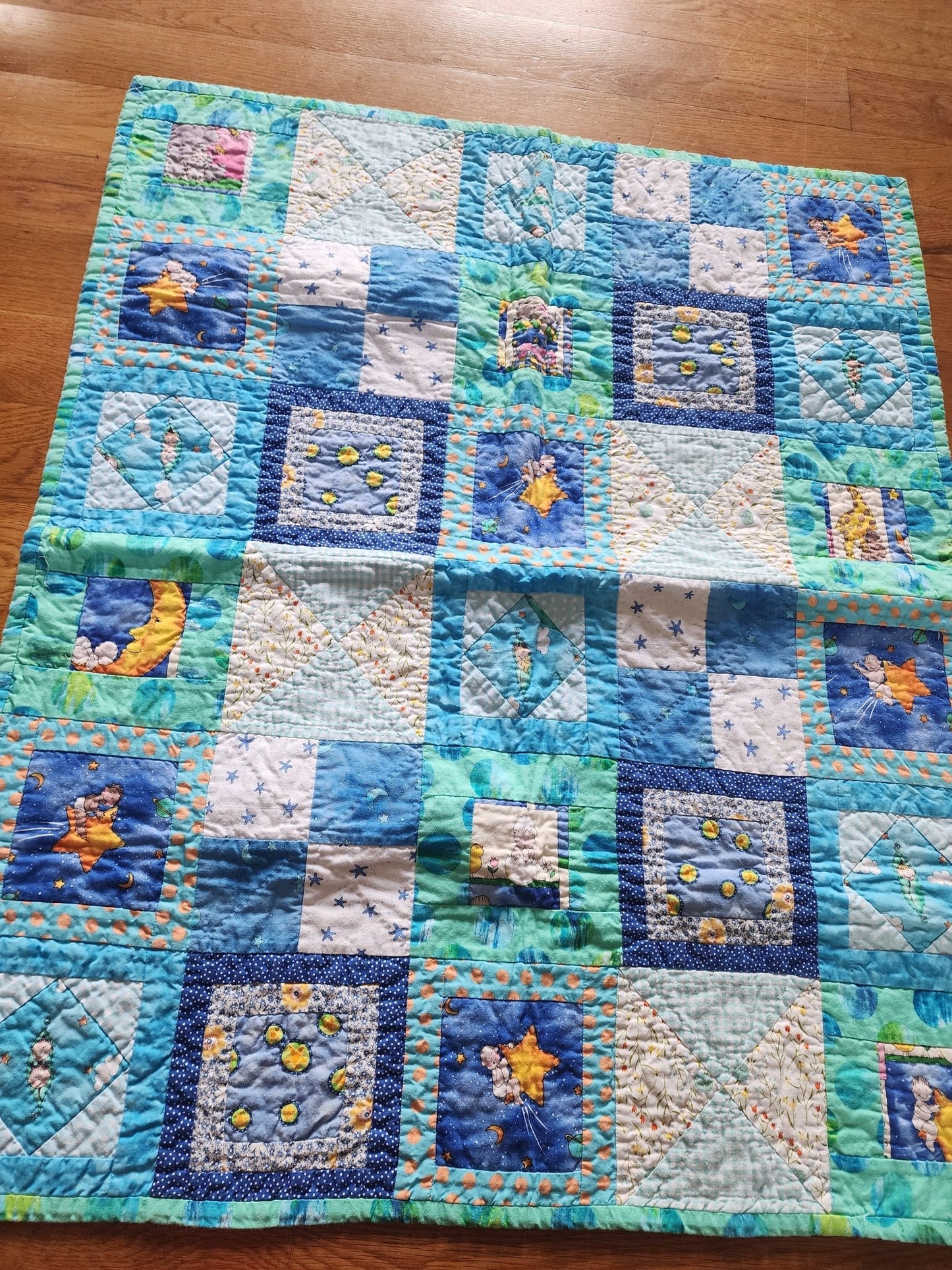 Homemade baby quilt in blues greens and Yellows baby's riding stars. - I Bought a Yard Sale