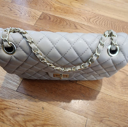 Quilted Leather beige purse with gold tone accents and chain.